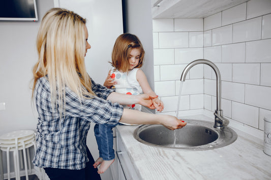 Family enjoying crystal quest water filtration system in modern kitchen countertop setup
