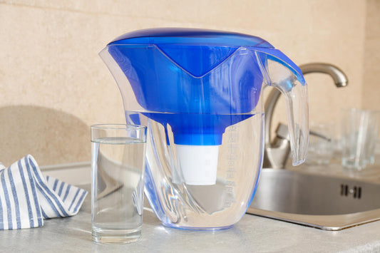 Modern eco friendly water filter system filling glass with clean filtered water in contemporary kitchen