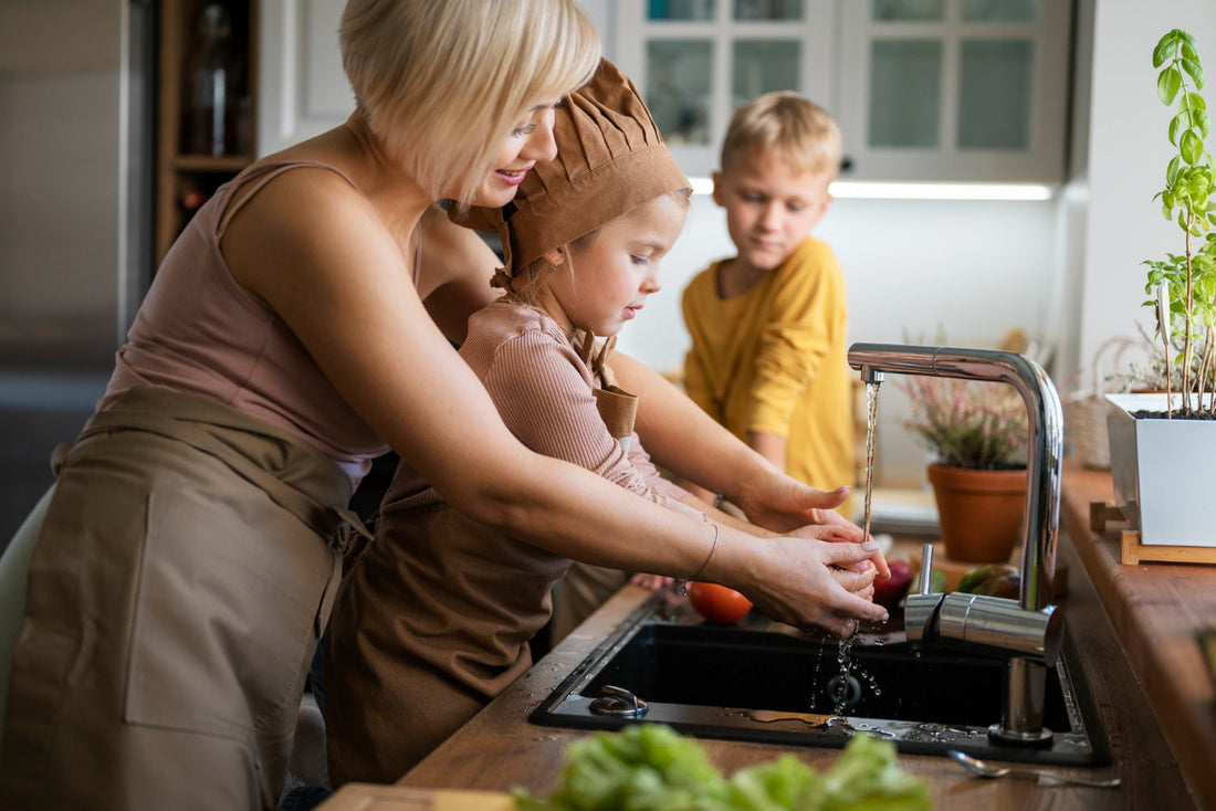 Family enjoying clean well water from whole house filtration system in modern kitchen