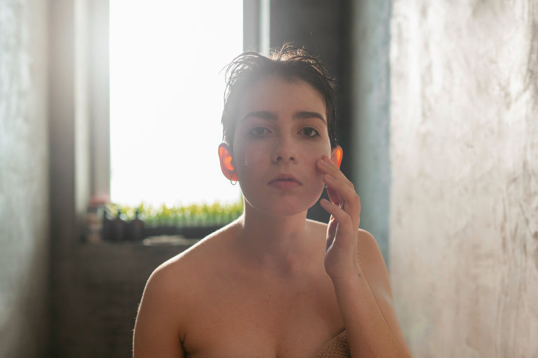 Person examining dry, irritated skin after showering with unfiltered chlorinated water