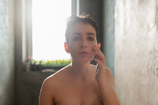 Person examining dry, irritated skin after showering with unfiltered chlorinated water
