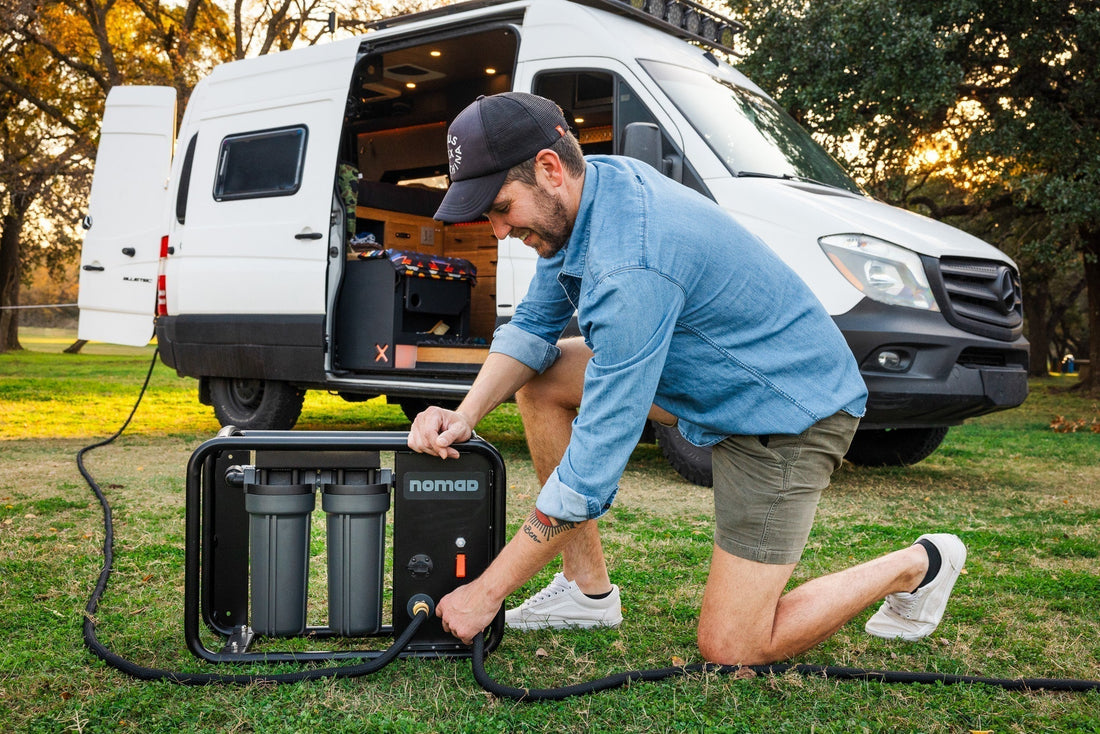 Rugged Nomad portable reverse osmosis system for RV, installed outdoors at campsite.