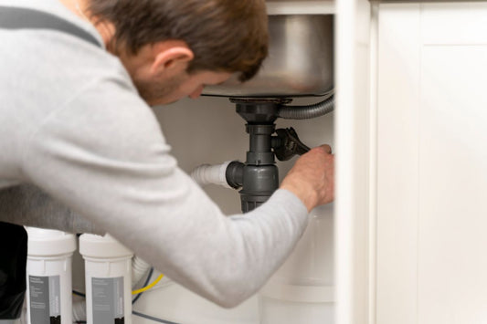 Man inspecting new water filter housing before installation