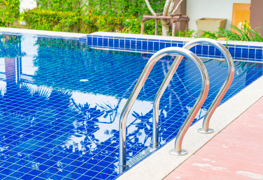 Sparkling clean pool under a clear blue sky.