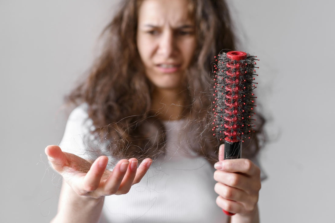 Woman brushing tangled hair caused by hard water.