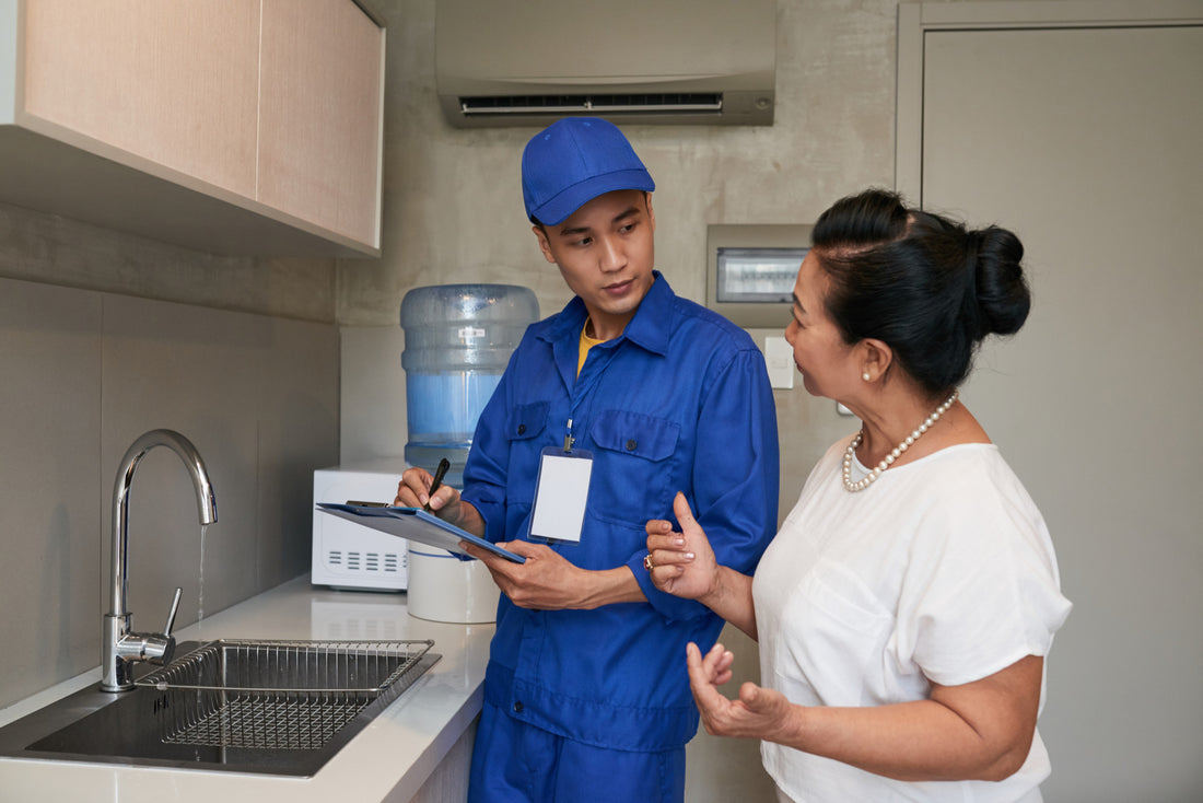 Plumber talking to a woman after intalling a water system