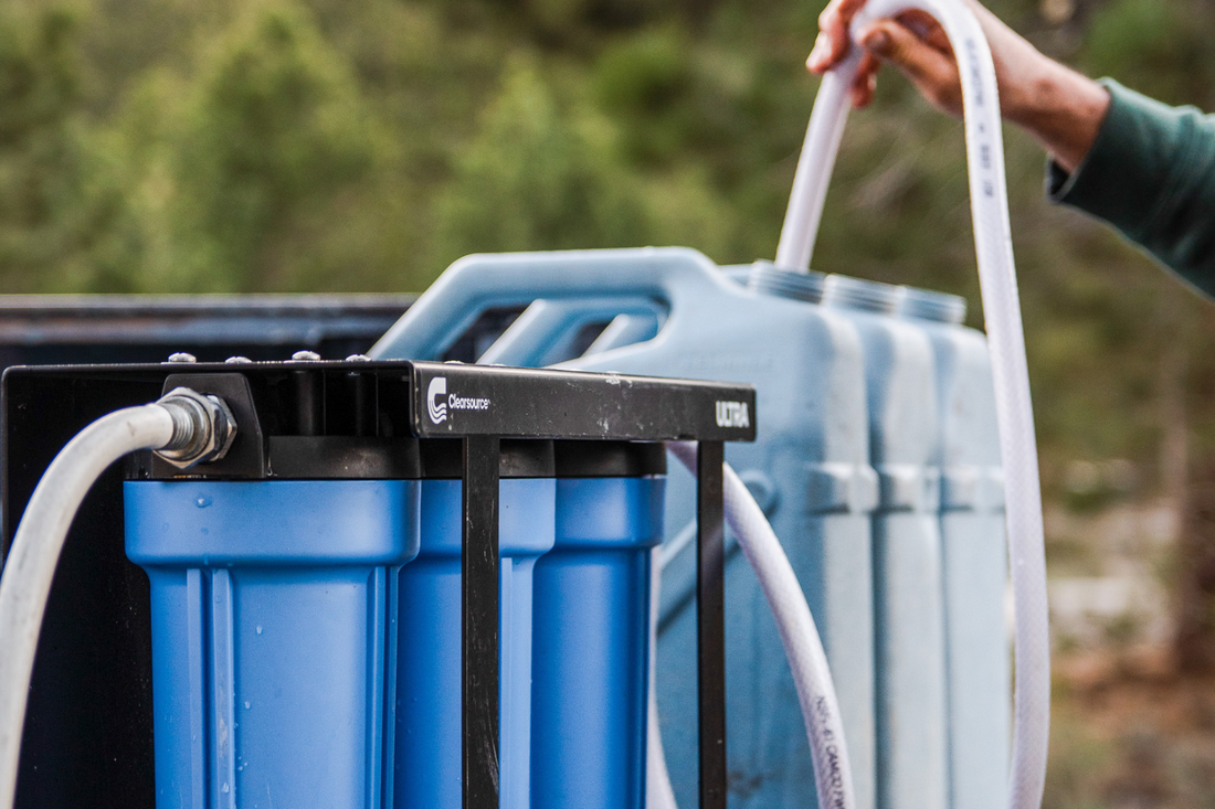 Portable water filtration system collecting clean rainwater for off-grid camping