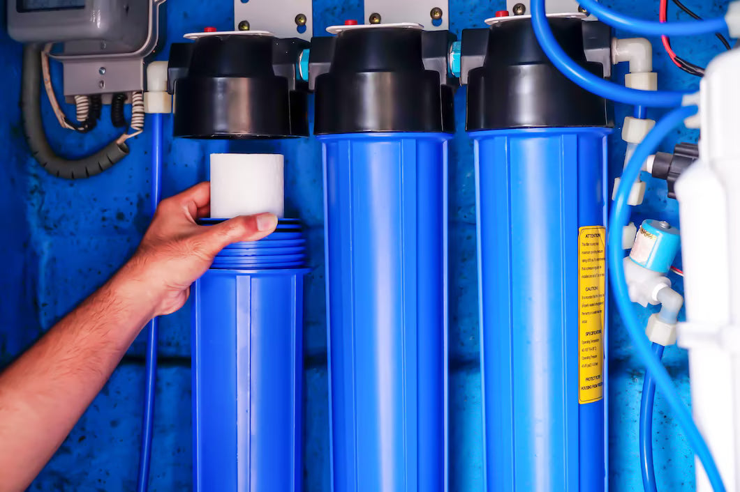 Professional installing Crystal Quest whole house water filter for maximum conservation efficiency