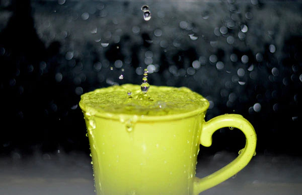 Raindrops falling into a ceramic mug